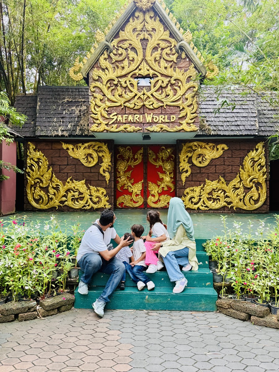 The five of us on the steps of a carved gilded gateway