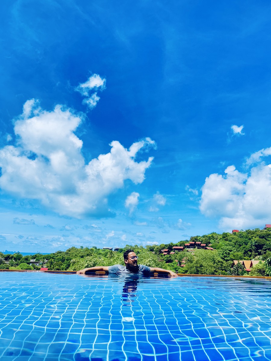 Floating in a pool that looks out over the treeline